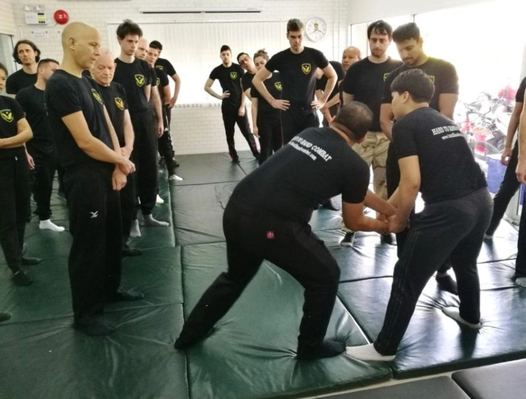 CMLocals Chiang Mai Locals Hand-to-Hand Combat ED Visa group of students watching instructor demonstration
